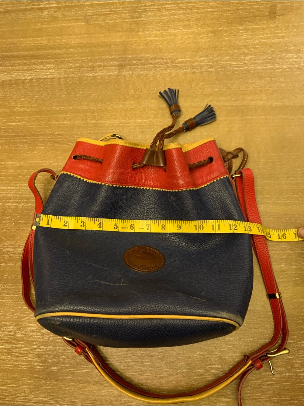 Dooney & Bourke Navy, Red & Yellow Leather Drawstring Bucket Bag - Picture 15 of 16